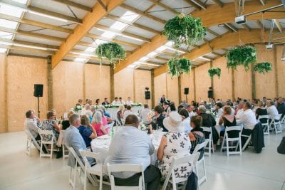 hanging greenery wreaths with wood walls for wedding