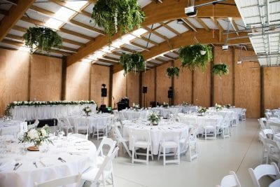 white and green shed wedding with hire tables and chairs