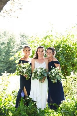 bride and navy colored bridesmaids with white and green bouquets