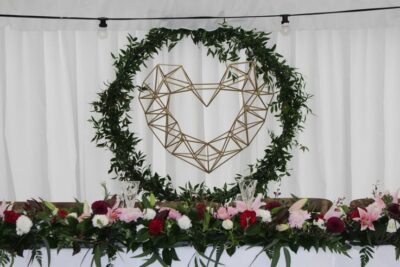 gold geometric heart backdrop with greenery