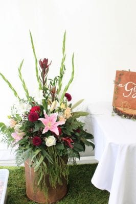 cream can arrangement in pinks and burgandys